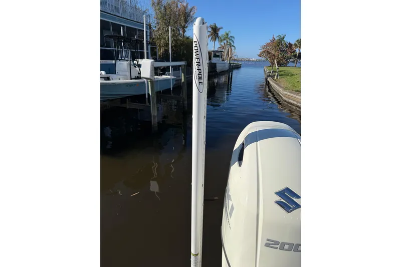 Slide: The Image of 2020 Tideline 235 Hybrid boat with Suzuki 200 engine docked by a canal. - 8