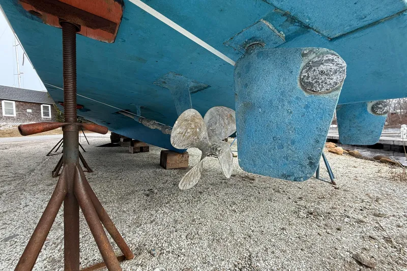 Slide: The Image of 1979 Hatteras 46 Convertible boat hull and propeller on dry dock. - 10