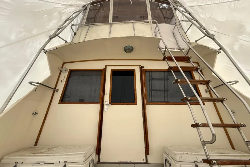 Slide: The Image of 1979 Hatteras 46 Convertible yacht stern view with ladder and door. - 14