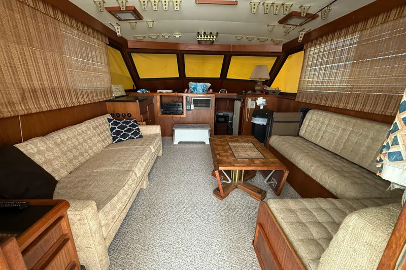 Slide: The Image of Interior of 1979 Hatteras 46 Convertible yacht with cozy seating and wooden accents. - 15