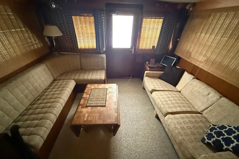 Slide: The Image of Interior of 1979 Hatteras 46 Convertible yacht with beige seating and wooden accents. - 17