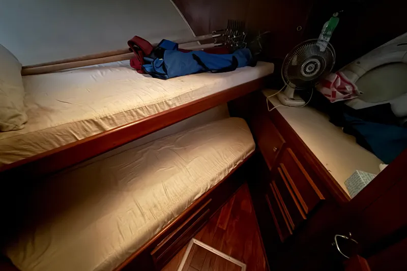 Slide: The Image of Cozy cabin interior of 1979 Hatteras 46 Convertible with bunk beds and fan. - 23