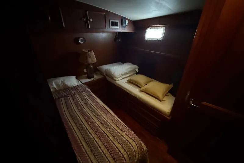 Slide: The Image of Cozy cabin interior of 1979 Hatteras 46 Convertible yacht with twin beds. - 24