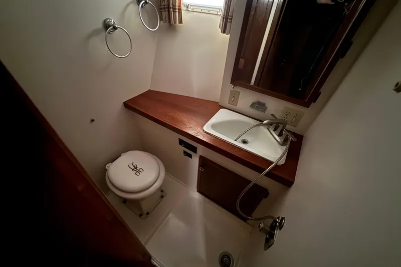 Slide: The Image of Bathroom interior of 1979 Hatteras 46 Convertible yacht with sink and toilet. - 25