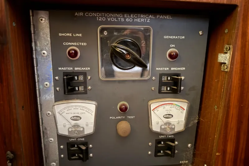 Slide: The Image of Electrical panel of a 1979 Hatteras 46 Convertible boat, showing breakers and meters. - 26