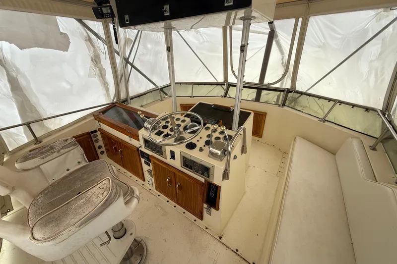 Slide: The Image of 1979 Hatteras 46 Convertible boat helm with vintage controls and seating. - 28