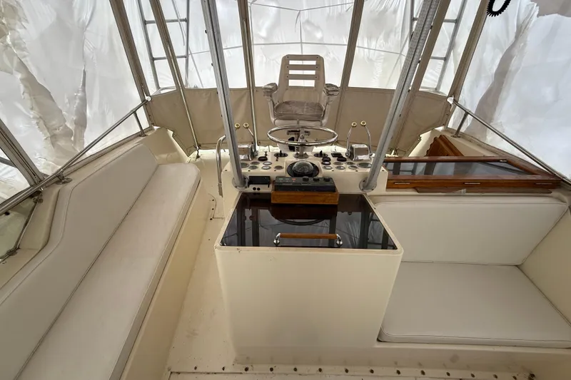Slide: The Image of Interior helm of 1979 Hatteras 46 Convertible yacht with seating and controls. - 29