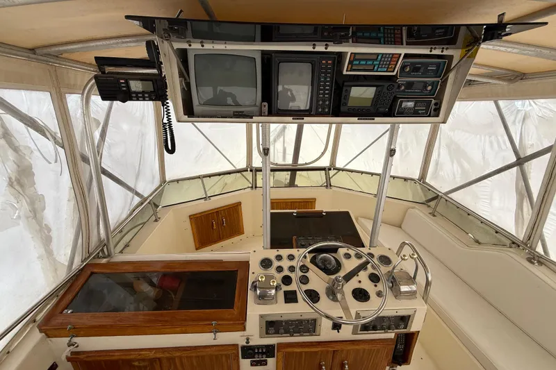 Slide: The Image of 1979 Hatteras 46 Convertible helm with vintage controls and navigation equipment. - 30