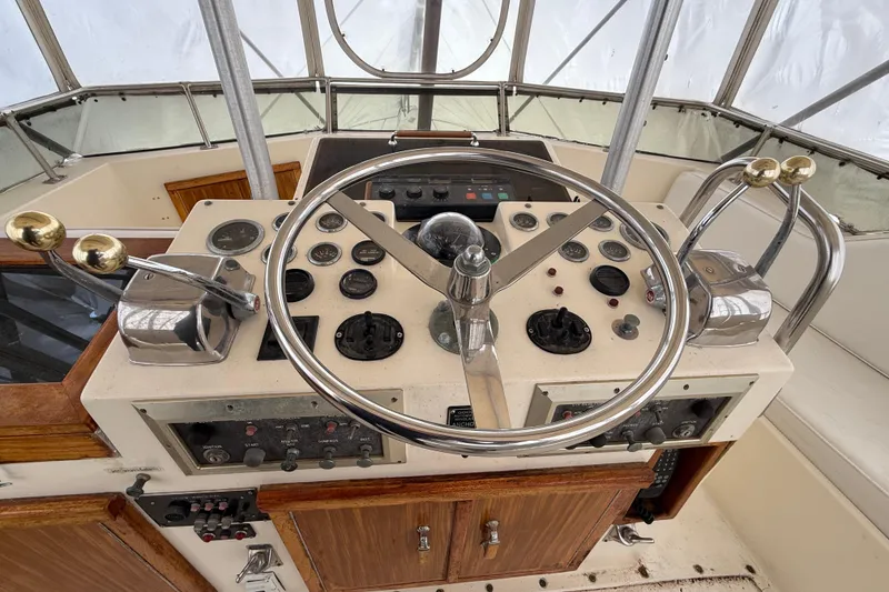 Slide: The Image of Helm of 1979 Hatteras 46 Convertible yacht with steering wheel and control panel. - 31