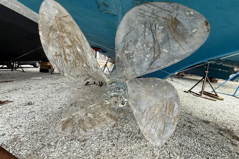 Slide: The Image of Propeller of a 1979 Hatteras 46 Convertible boat on gravel surface. - 8