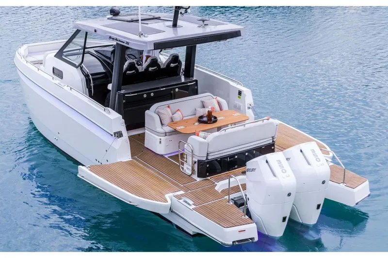 Slide: The Image of Manufacturer Provided Image: 2025 Beneteau Gran Turismo 35 yacht with twin outboard engines on calm water. - 2