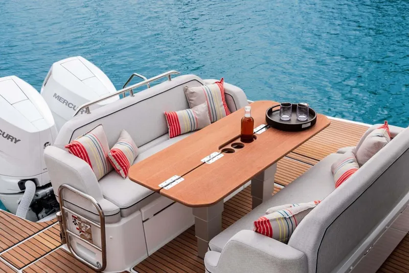 Slide: The Image of Manufacturer Provided Image: Luxury seating area on 2025 Beneteau Gran Turismo 35 yacht with table and cushions. - 5