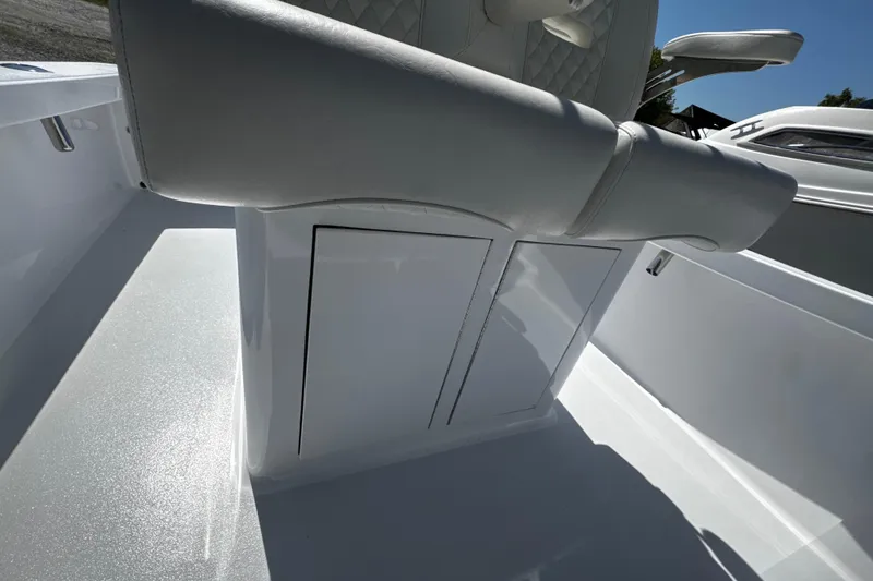 Slide: The Image of Luxury seating on a 2025 Weaver 25 boat, featuring sleek white design and storage compartments. - 10