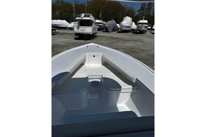 Slide: The Image of Bow view of a 2025 Weaver 25 boat in a marina with other vessels. - 7