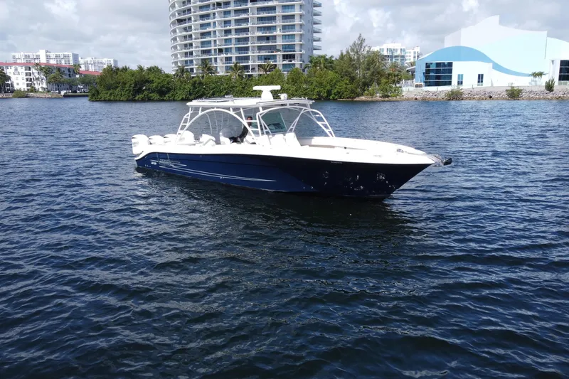 The Image of 2012 Hydra-Sports 4200 SF boat on calm water with urban skyline backdrop. - 0