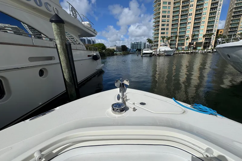 Slide: The Image of Bow view of 2012 Hydra-Sports 4200 SF in marina, surrounded by yachts and high-rise buildings. - 15