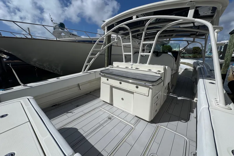 Slide: The Image of 2012 Hydra-Sports 4200 SF boat interior with spacious deck and seating under blue sky. - 2
