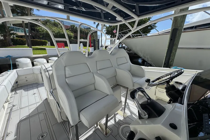Slide: The Image of Interior view of a 2012 Hydra-Sports 4200 SF boat with white seating and steering wheel. - 7