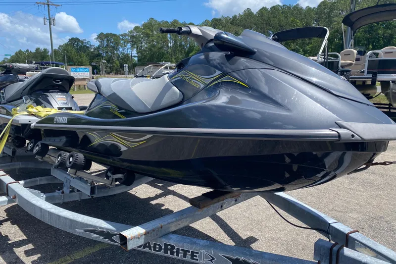 Slide: The Image of 2014 Yamaha WaveRunner VX Deluxe on trailer, parked outdoors under clear sky. - 2