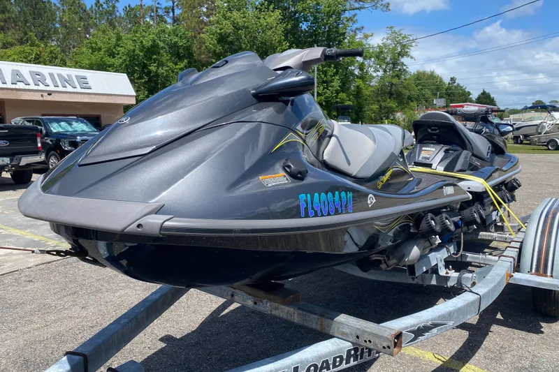Slide: The Image of 2014 Yamaha WaveRunner VX Deluxe on trailer, parked outdoors near marine shop. - 3