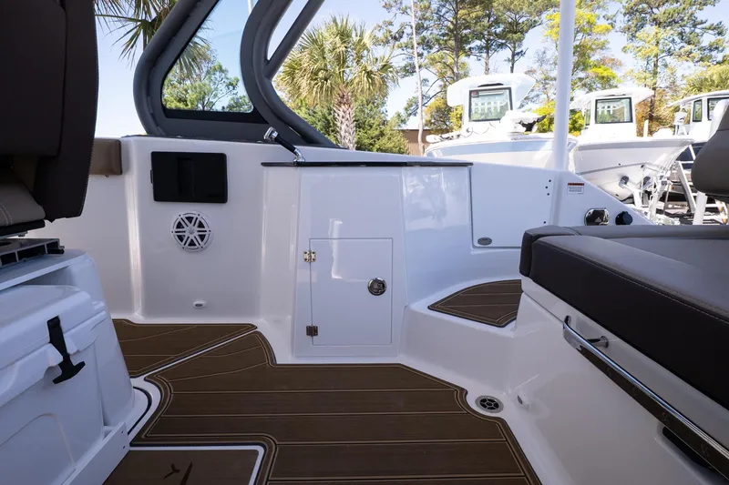 Slide: The Image of 2026 Monterey Elite 25 OB boat interior with seating and storage compartments. - 11
