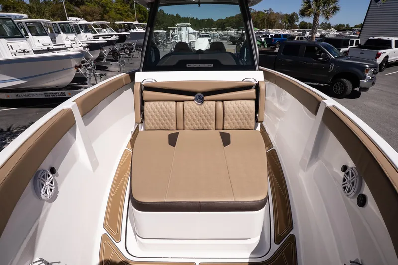 Slide: The Image of 2026 Monterey Elite 25 OB boat interior with tan seating and modern design. - 14