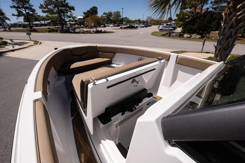 Slide: The Image of 2026 Monterey Elite 25 OB boat with tan seating and sleek design in a sunny setting. - 15