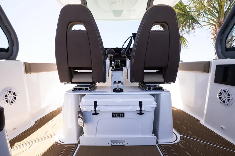 Slide: The Image of 2026 Monterey Elite 25 OB boat interior with dual seats and Yeti cooler. - 21