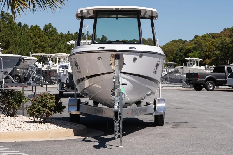 Slide: The Image of 2026 Monterey Elite 25 OB boat on trailer in marina parking lot. - 3