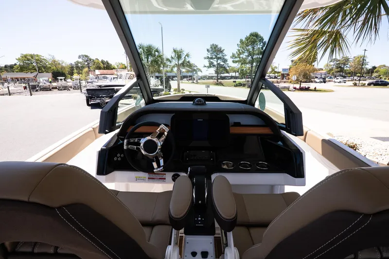 Slide: The Image of Interior view of 2026 Monterey Elite 25 OB boat cockpit with steering wheel. - 8