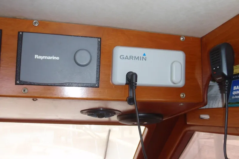 Slide: The Image of 1985 Ocean Alexander boat dashboard with Raymarine and Garmin navigation equipment. - 44