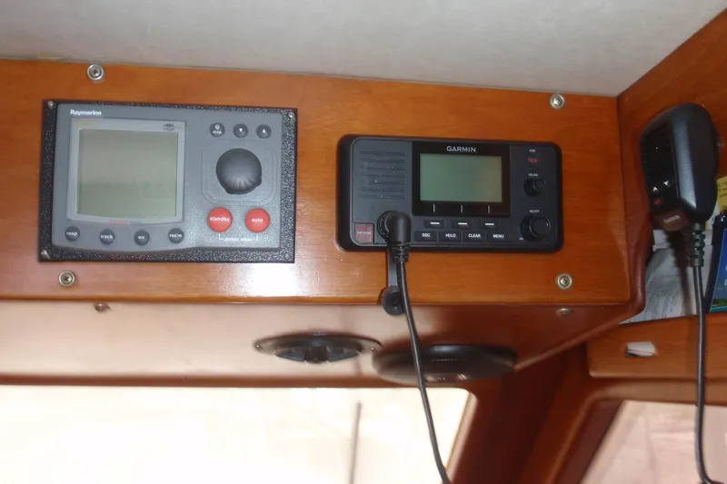 Slide: The Image of 1985 Ocean Alexander boat dashboard with Raymarine and Garmin navigation equipment. - 45