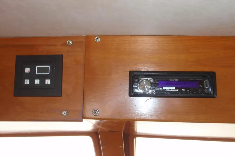 Slide: The Image of 1985 Ocean Alexander interior with Kenwood stereo and control panel on wooden dashboard. - 48