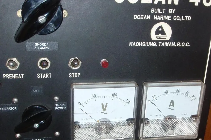 Slide: The Image of Electrical service panel of a 1985 Ocean Alexander boat with gauges and switches. - 54