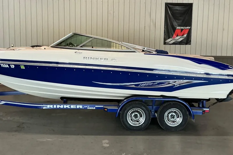 The Image of 2008 Rinker 226 Captiva Bowrider on trailer in indoor showroom. - 1