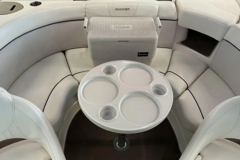 Slide: The Image of 2008 Rinker 226 Captiva Bowrider interior with seating and table setup. - 10