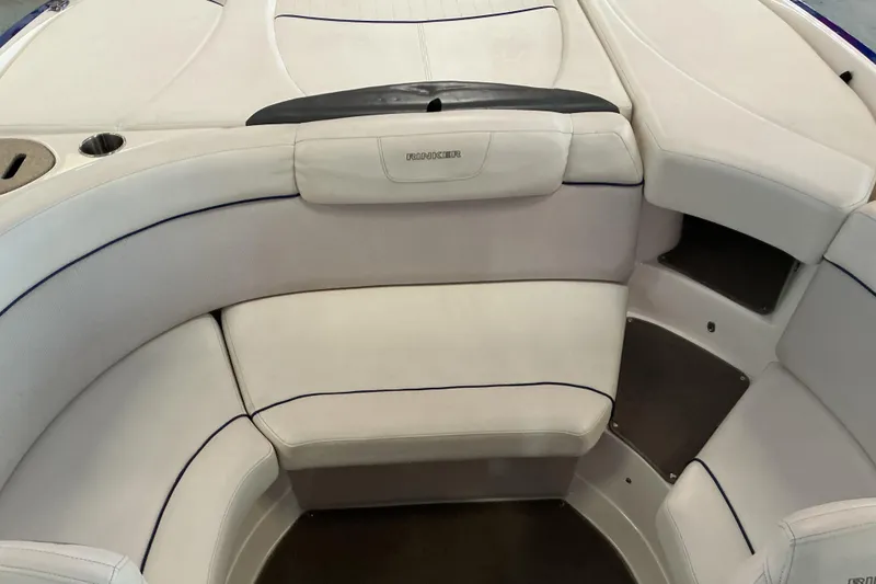 Slide: The Image of 2008 Rinker 226 Captiva Bowrider interior with white cushioned seating and cup holder. - 11