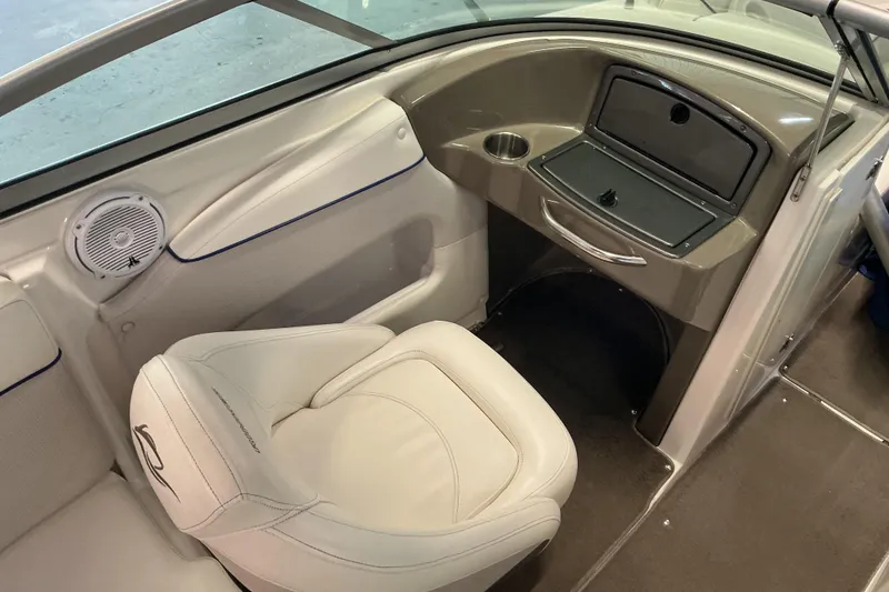 Slide: The Image of 2008 Rinker 226 Captiva Bowrider interior with white seating and dashboard. - 14