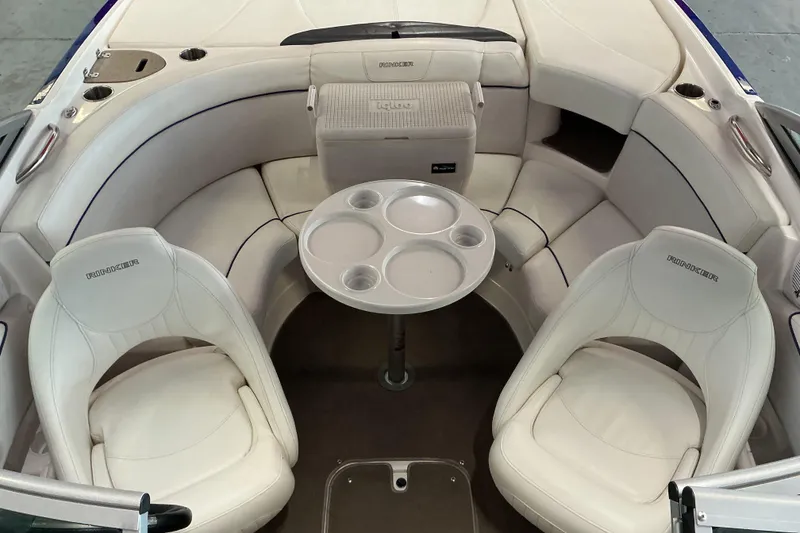 Slide: The Image of 2008 Rinker 226 Captiva Bowrider interior with white seating and round table. - 15