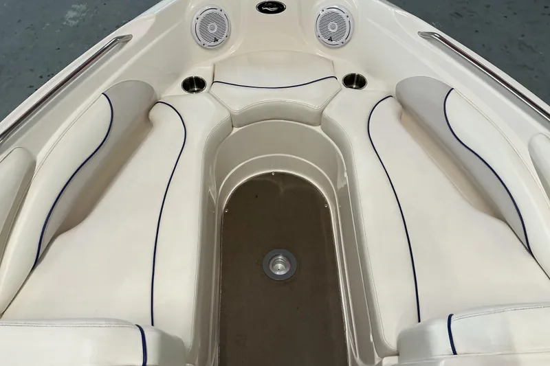 Slide: The Image of 2008 Rinker 226 Captiva Bowrider interior with white seating and cup holders. - 17