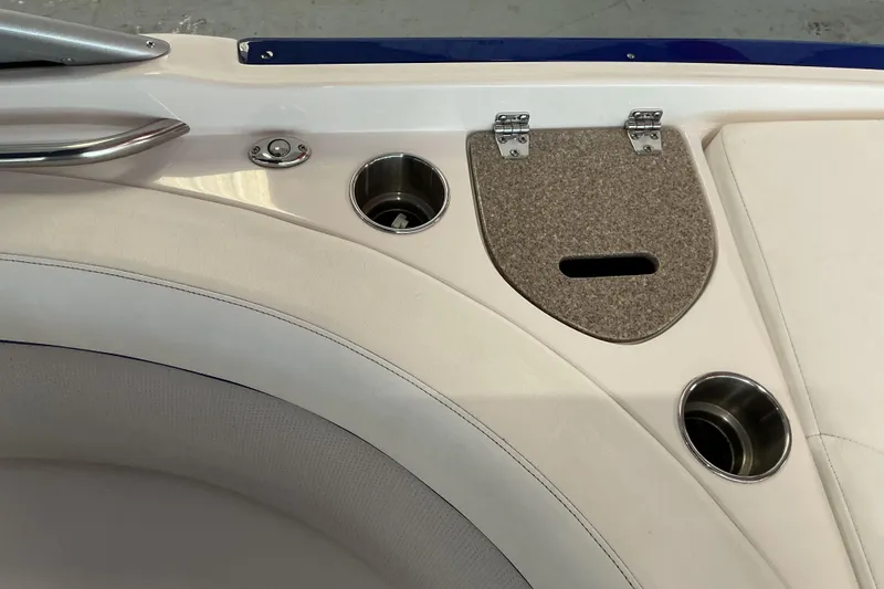 Slide: The Image of 2008 Rinker 226 Captiva Bowrider interior with cup holders and storage compartment. - 18