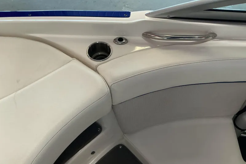 Slide: The Image of Interior of 2008 Rinker 226 Captiva Bowrider with white seating and cup holder. - 19