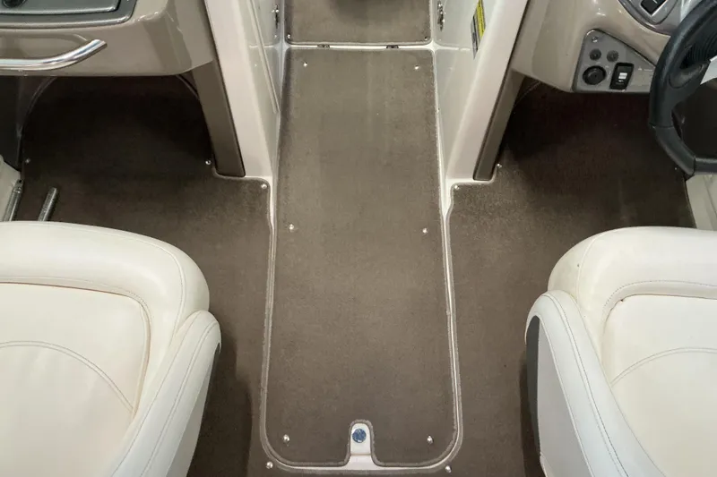 Slide: The Image of 2008 Rinker 226 Captiva Bowrider interior with beige seats and brown carpet flooring. - 20