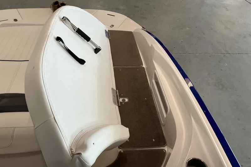 Slide: The Image of 2008 Rinker 226 Captiva Bowrider interior with white seating and carpeted flooring. - 21