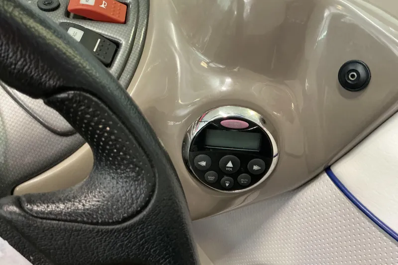 Slide: The Image of Steering wheel and control panel of 2008 Rinker 226 Captiva Bowrider boat. - 22