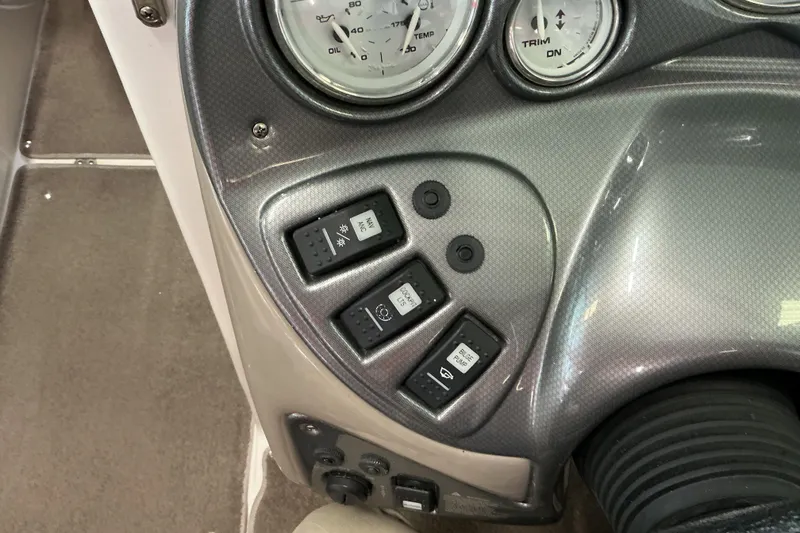 Slide: The Image of Dashboard controls of a 2008 Rinker 226 Captiva Bowrider boat with gauges and switches. - 23