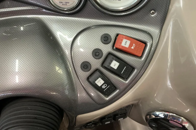 Slide: The Image of Dashboard controls of a 2008 Rinker 226 Captiva Bowrider boat, featuring switches and gauges. - 24