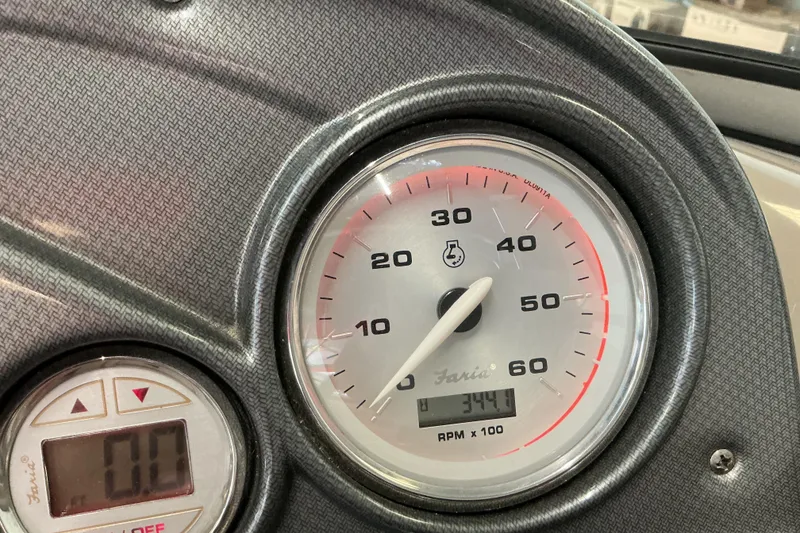 Slide: The Image of Dashboard of 2008 Rinker 226 Captiva Bowrider showing tachometer and digital display. - 31