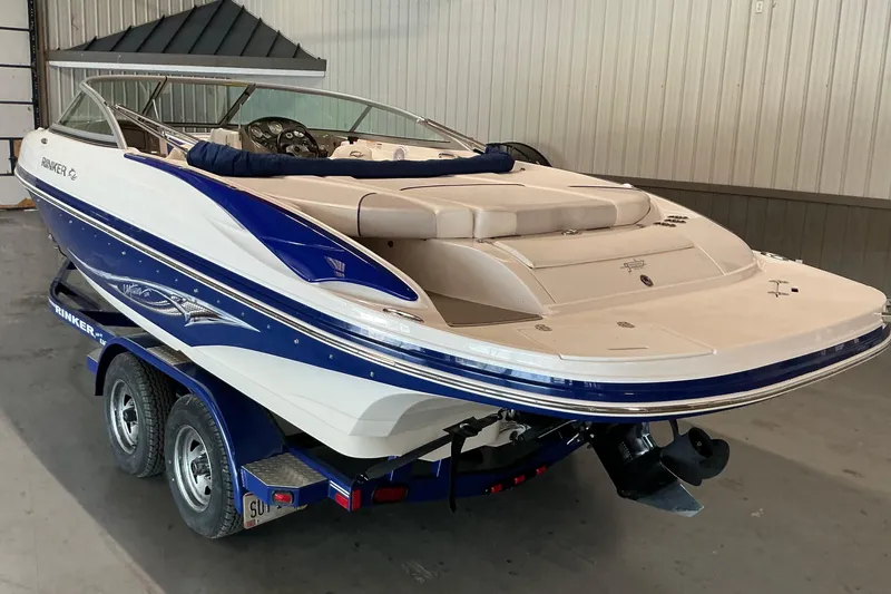 Slide: The Image of 2008 Rinker 226 Captiva Bowrider boat on trailer in indoor storage. - 4