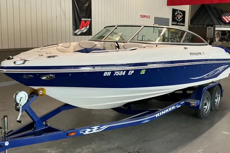 Slide: The Image of 2008 Rinker 226 Captiva Bowrider boat on trailer in indoor showroom. - 5